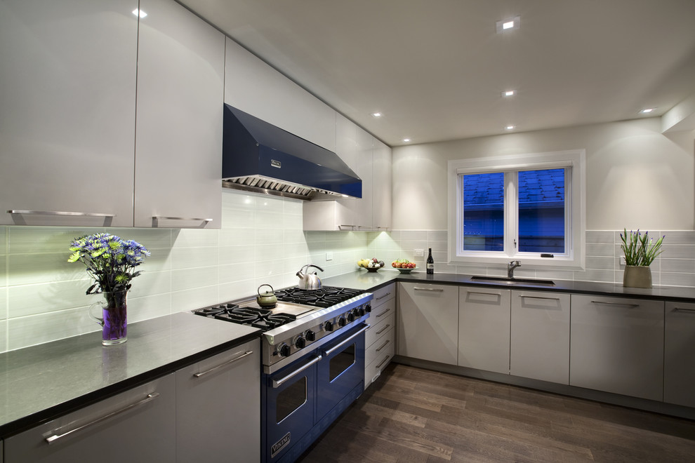 Photo of a contemporary kitchen in Vancouver with coloured appliances, flat-panel cabinets and white cabinets.