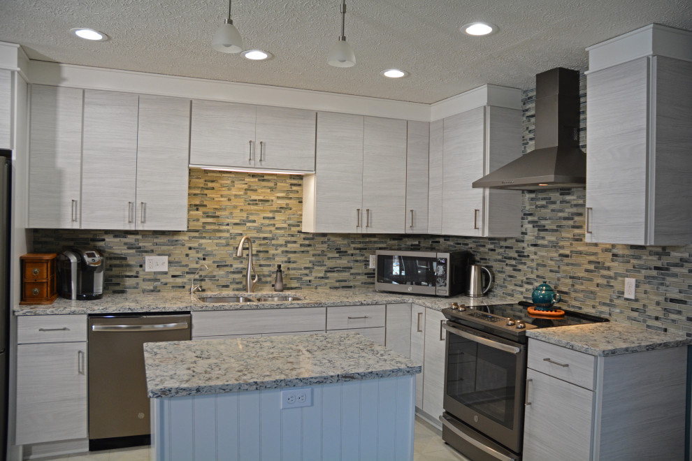 Inspiration for a mid-sized contemporary l-shaped beige floor enclosed kitchen remodel in Other with an undermount sink, flat-panel cabinets, white cabinets, quartzite countertops, gray backsplash, glass tile backsplash, stainless steel appliances, an island and multicolored countertops