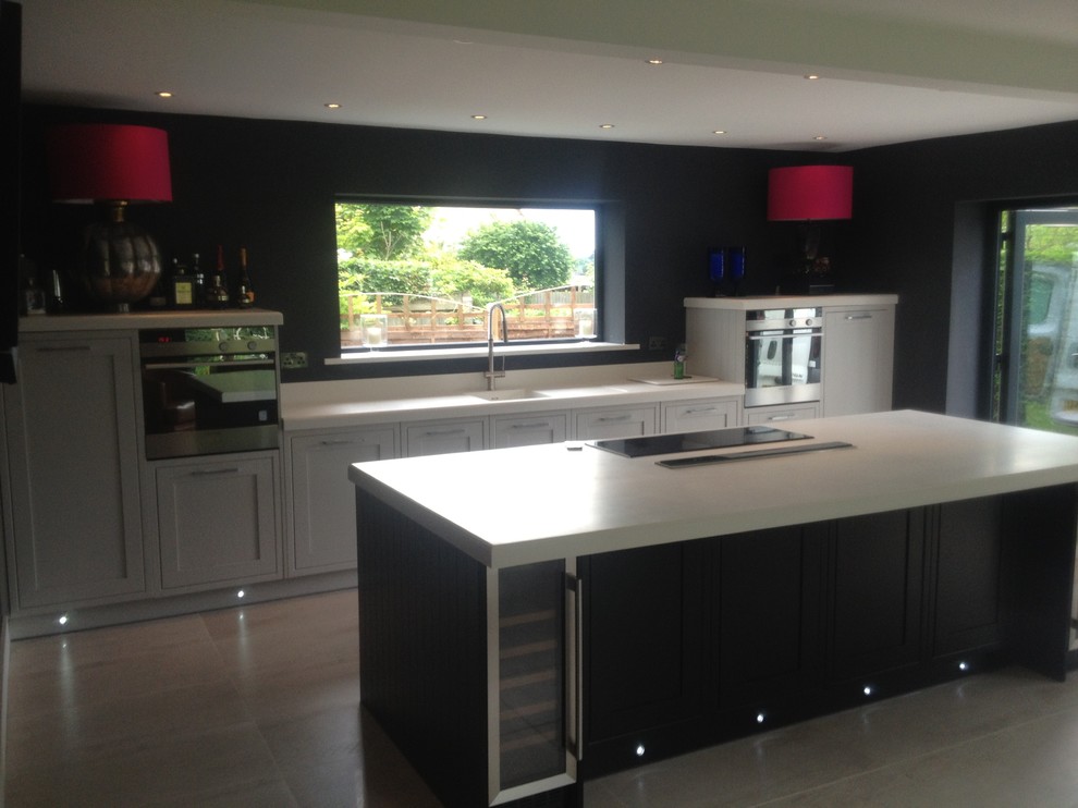 This is an example of a medium sized contemporary single-wall open plan kitchen in Other with an integrated sink, composite countertops, porcelain flooring and an island.