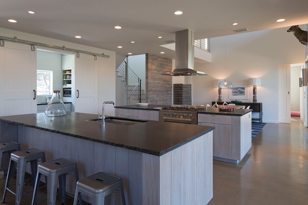Contemporary open plan kitchen in Austin with a submerged sink and stainless steel appliances.