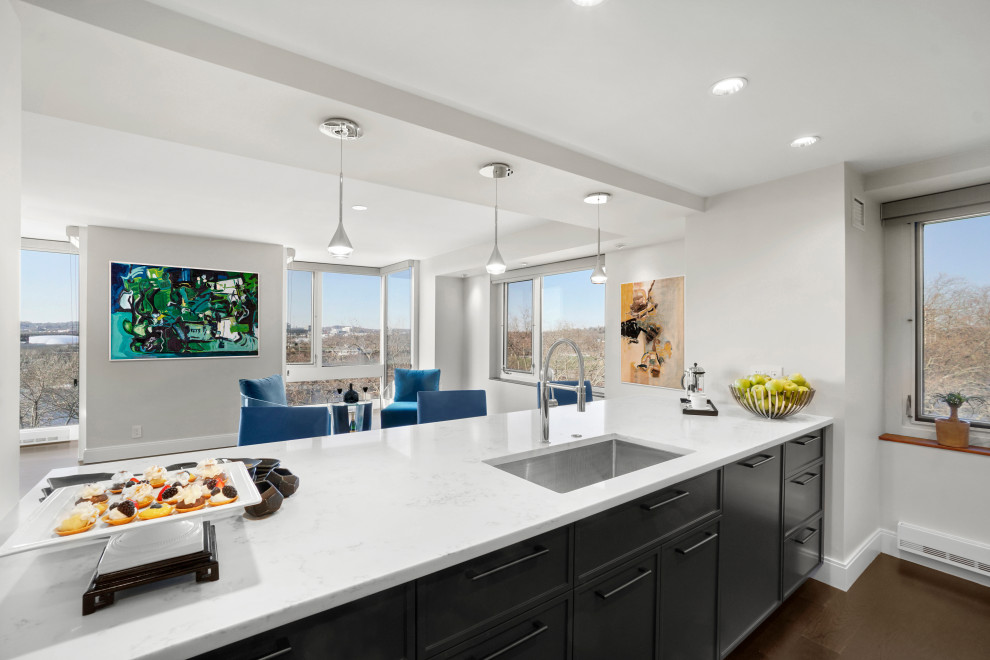 Mid-sized trendy l-shaped dark wood floor and brown floor eat-in kitchen photo in Boston with an undermount sink, shaker cabinets, blue cabinets, quartz countertops, blue backsplash, glass tile backsplash, paneled appliances, an island and white countertops