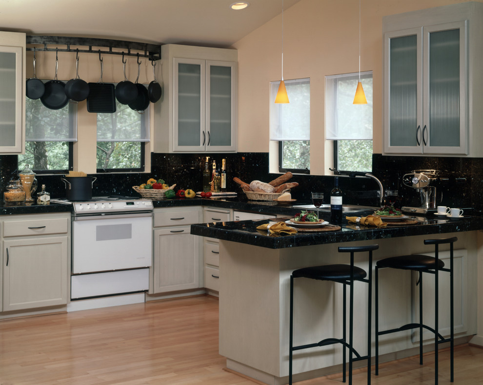 Contemporary kitchen in San Francisco with glass-front cabinets, white cabinets and black splashback.