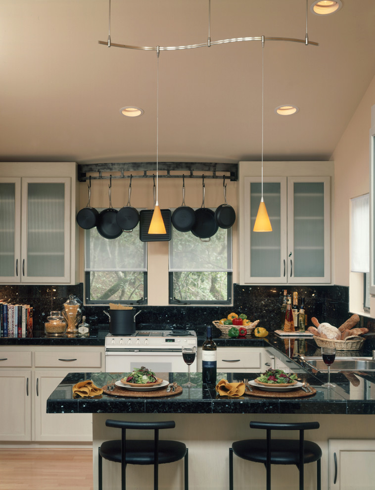 Trendy kitchen photo in San Francisco with glass-front cabinets, beige cabinets, black backsplash and white appliances