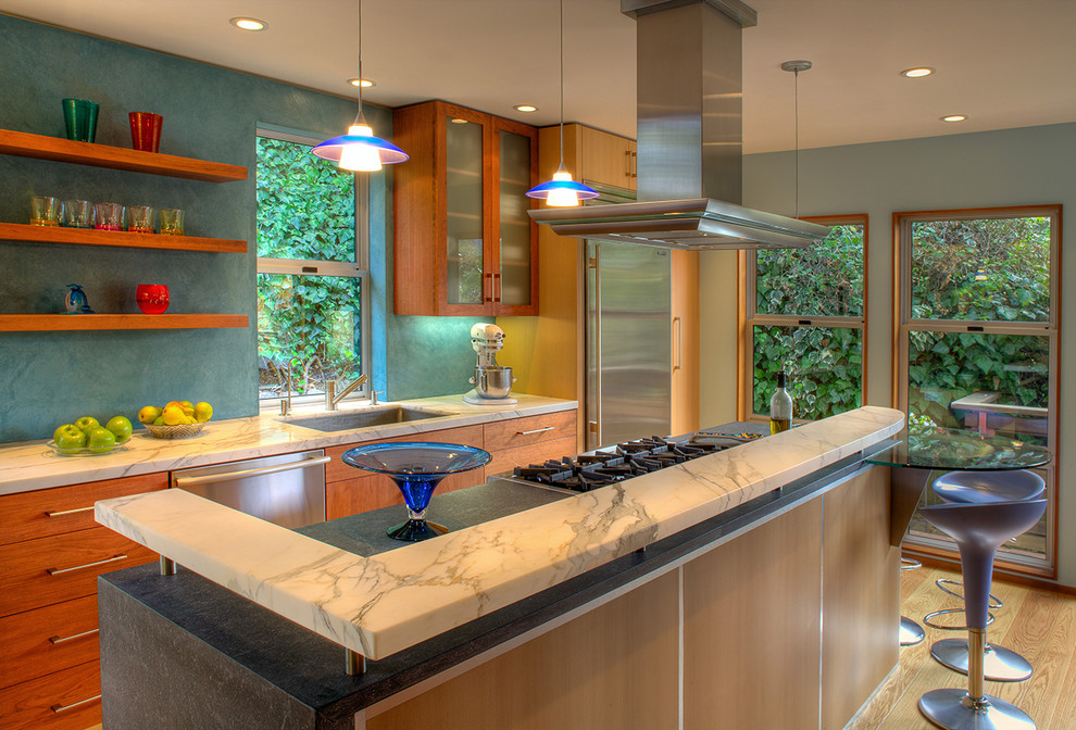 This is an example of a contemporary kitchen in San Francisco with flat-panel cabinets, light wood cabinets and stainless steel appliances.