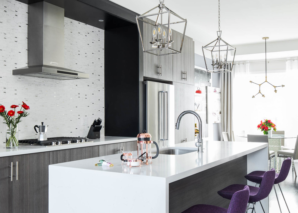 This is an example of a large contemporary grey and purple kitchen/diner in Toronto with flat-panel cabinets, dark wood cabinets, engineered stone countertops, stainless steel appliances, dark hardwood flooring, an island, white worktops, a submerged sink, metallic splashback and metal splashback.