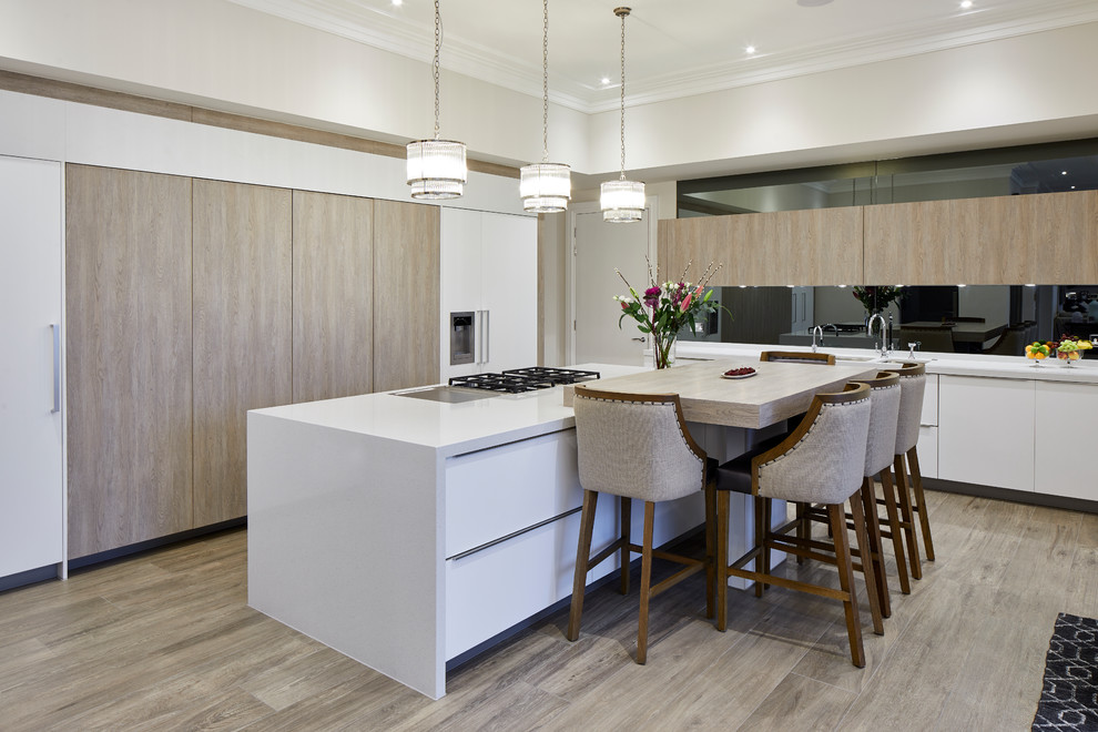 Inspiration for a large modern l-shaped porcelain tile and brown floor eat-in kitchen remodel in London with a double-bowl sink, flat-panel cabinets, light wood cabinets, quartzite countertops, gray backsplash, mirror backsplash, stainless steel appliances, an island and white countertops