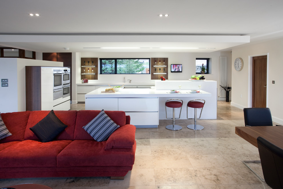This is an example of a large contemporary open plan kitchen in Belfast with a built-in sink, flat-panel cabinets and white cabinets.