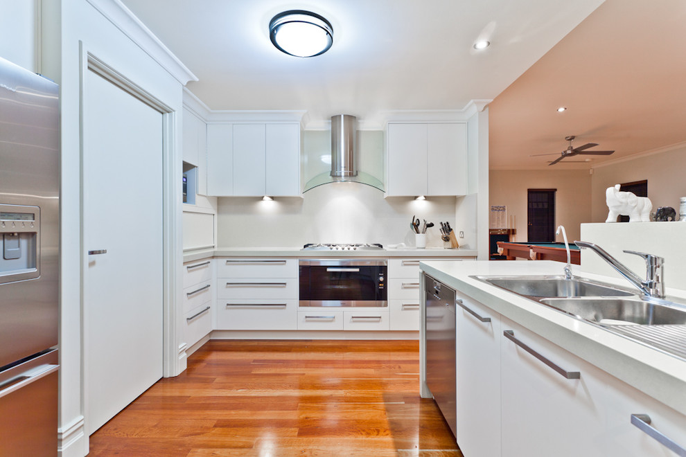 Example of a trendy open concept kitchen design in Perth with a drop-in sink, flat-panel cabinets, white cabinets and stainless steel appliances
