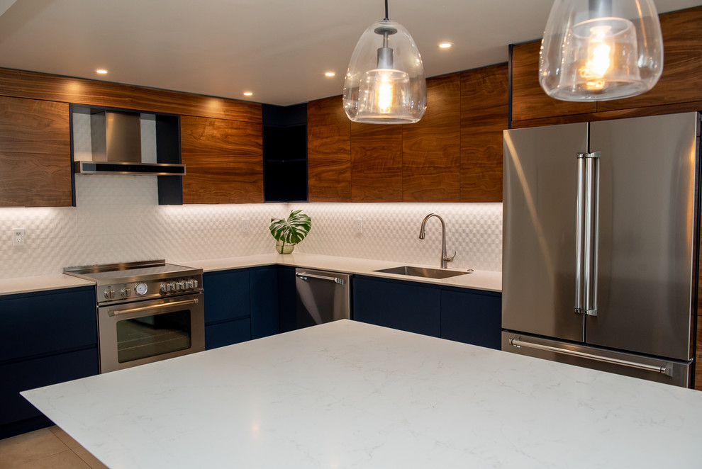 Large trendy l-shaped eat-in kitchen photo in Miami with an island