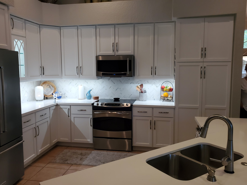 Photo of a medium sized contemporary l-shaped kitchen/diner in Miami with a submerged sink, engineered stone countertops and an island.