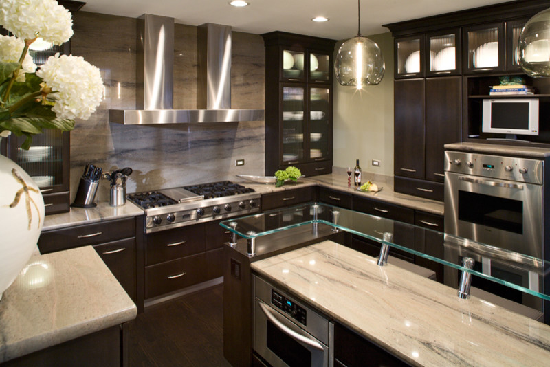 Kitchen - contemporary kitchen idea in Chicago with glass countertops and stone slab backsplash