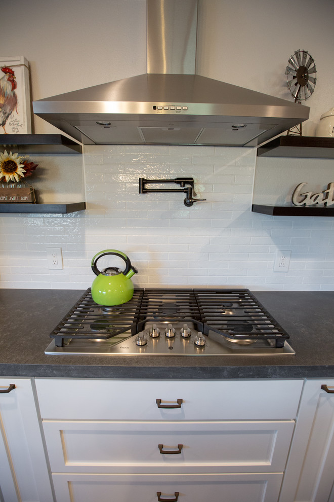 Inredning av ett modernt grå grått kök, med en rustik diskho, vita skåp, bänkskiva i kvarts, vitt stänkskydd, stänkskydd i keramik, rostfria vitvaror, klinkergolv i porslin, en köksö och flerfärgat golv