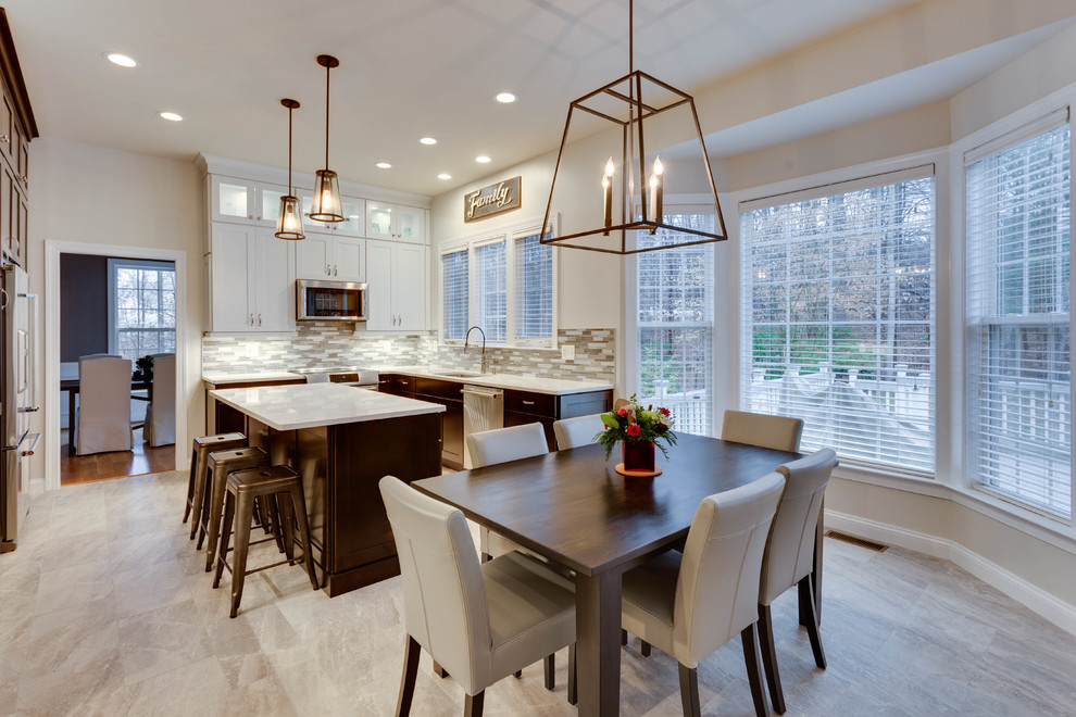 Photo of a medium sized contemporary u-shaped kitchen/diner in DC Metro with a submerged sink, shaker cabinets, engineered stone countertops, stainless steel appliances and an island.