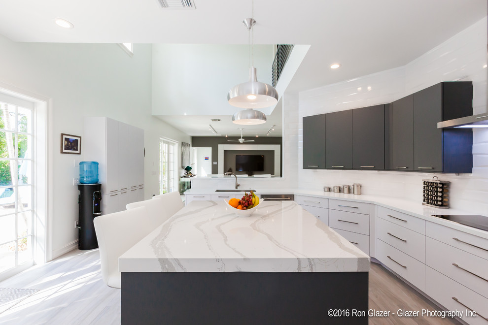 Example of a trendy kitchen design in Miami with an undermount sink, white cabinets, quartz countertops, white backsplash, subway tile backsplash and paneled appliances