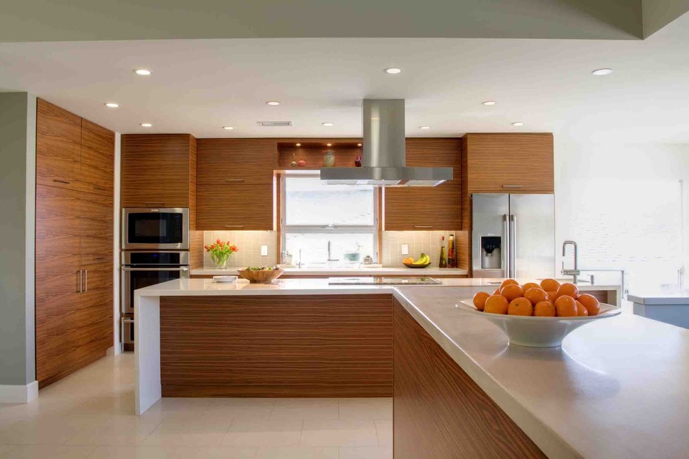 Exempel på ett stort modernt kök, med en undermonterad diskho, släta luckor, skåp i mellenmörkt trä, bänkskiva i kvarts, stänkskydd i glaskakel, rostfria vitvaror, en köksö och klinkergolv i porslin