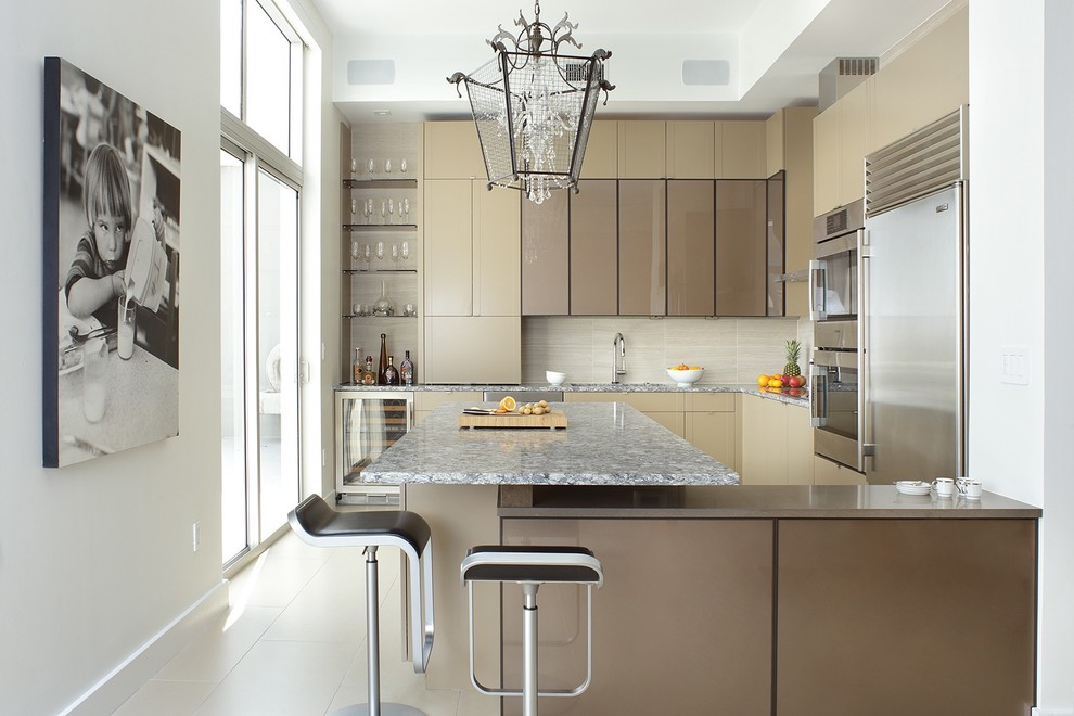 Mid-sized trendy u-shaped ceramic tile and beige floor enclosed kitchen photo in Other with flat-panel cabinets, beige cabinets, beige backsplash, stainless steel appliances, a peninsula, a single-bowl sink, quartz countertops and porcelain backsplash