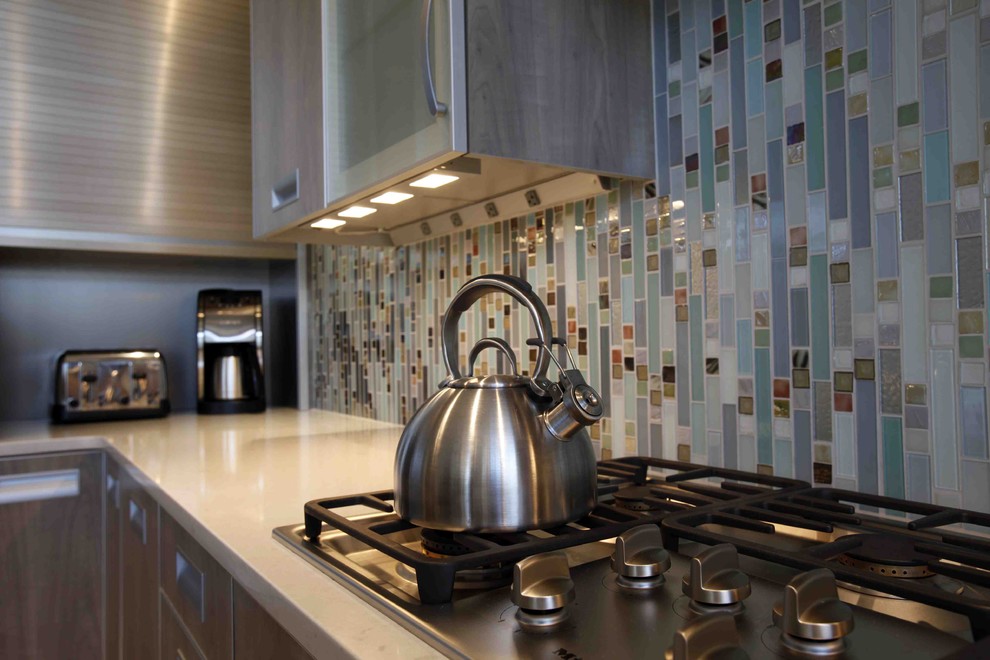 Inspiration for a mid-sized contemporary l-shaped porcelain tile eat-in kitchen remodel in Other with a farmhouse sink, flat-panel cabinets, gray cabinets and stainless steel appliances
