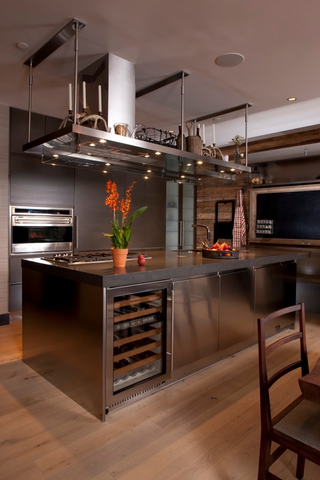Photo of a contemporary kitchen in Denver with flat-panel cabinets and stainless steel appliances.