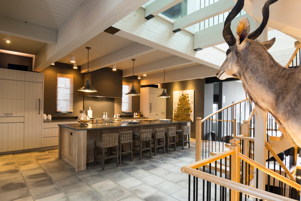 Inspiration for a modern single-wall kitchen remodel in Albuquerque with flat-panel cabinets, gray cabinets, granite countertops, black backsplash, paneled appliances and an island