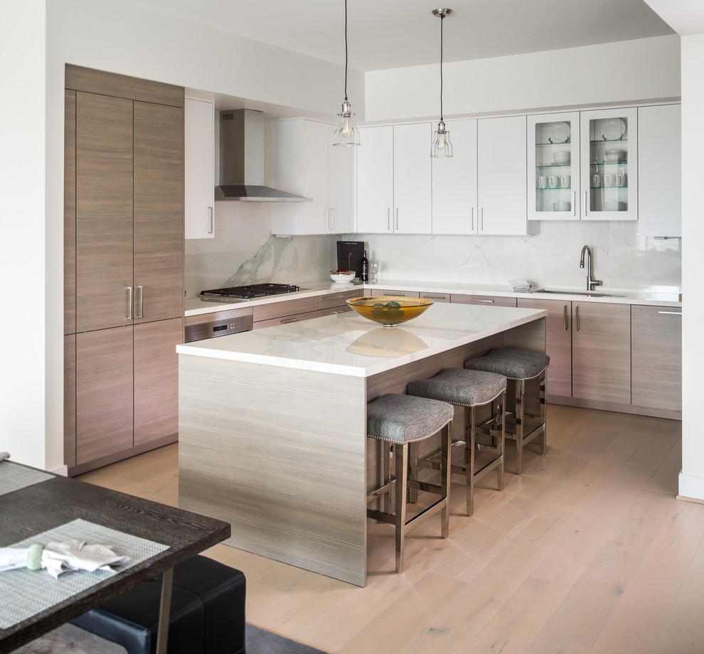 Kitchen - contemporary light wood floor and brown floor kitchen idea in Houston with an undermount sink, flat-panel cabinets, medium tone wood cabinets, white backsplash, an island and white countertops