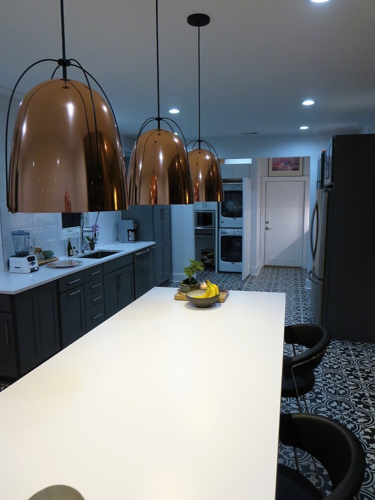 Foto di una cucina minimal chiusa e di medie dimensioni con lavello sottopiano, ante in stile shaker, elettrodomestici in acciaio inossidabile e pavimento multicolore