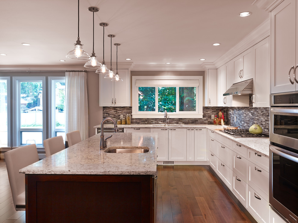 Inspiration for a contemporary kitchen remodel in Vancouver with white backsplash and an island