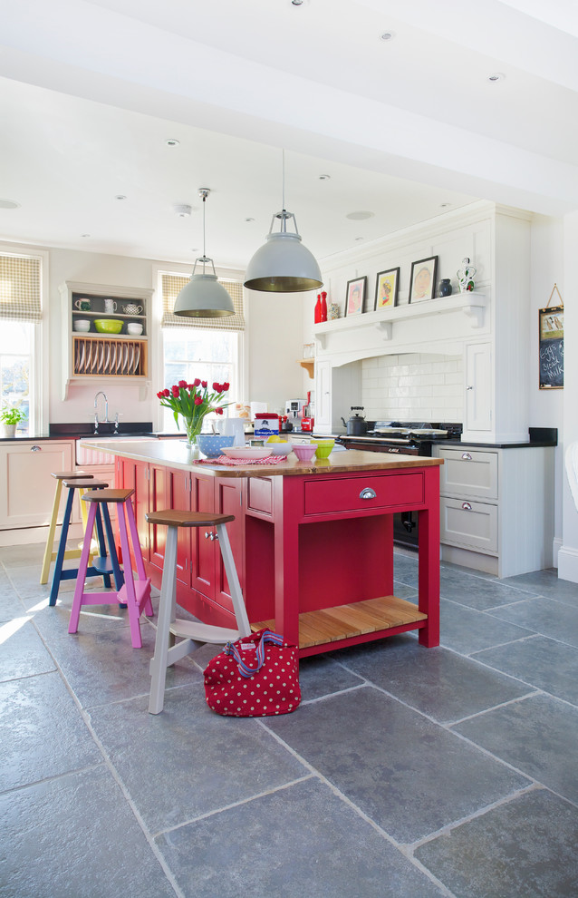 Inspiration for a transitional kitchen remodel in Kent with red cabinets, wood countertops, white backsplash, subway tile backsplash and an island