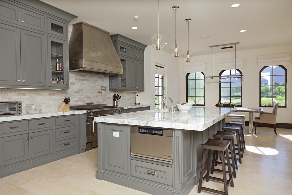 Trendy eat-in kitchen photo in San Diego with beaded inset cabinets, gray cabinets, gray backsplash, stainless steel appliances, marble countertops and travertine backsplash