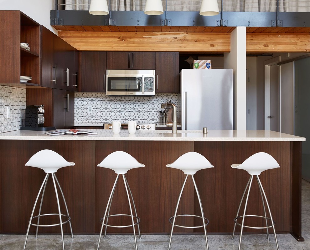 Example of a small trendy u-shaped open concept kitchen design in Seattle with quartzite countertops, white backsplash, flat-panel cabinets, dark wood cabinets, stainless steel appliances and a peninsula