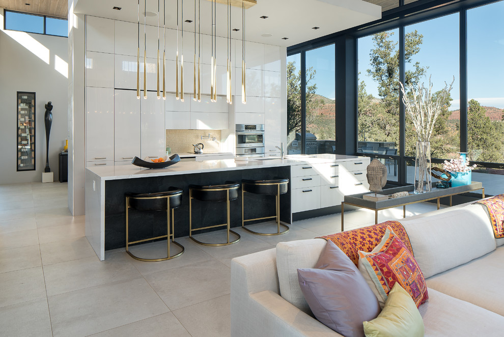 Inspiration for a small contemporary galley porcelain tile and beige floor open concept kitchen remodel in Phoenix with an undermount sink, flat-panel cabinets, white cabinets, quartz countertops, metallic backsplash, ceramic backsplash, stainless steel appliances and an island