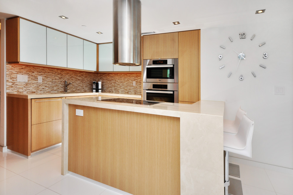 Contemporary l-shaped kitchen in Tampa with a submerged sink, flat-panel cabinets, light wood cabinets, multi-coloured splashback, matchstick tiled splashback, stainless steel appliances and white floors.