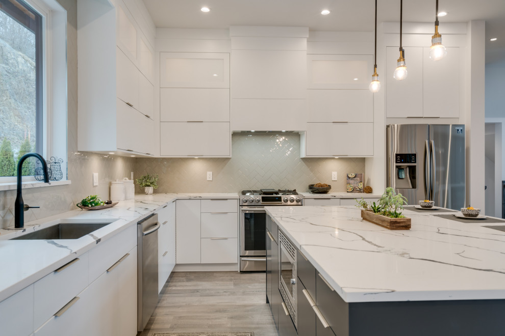 Contemporary Kitchen with Dark Faucet, Contrasting Island, and Quartz