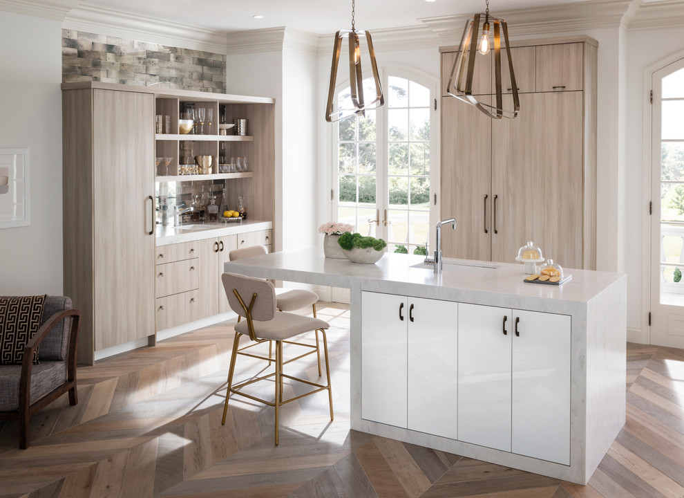 Design ideas for a contemporary kitchen/diner in Raleigh with flat-panel cabinets, light wood cabinets, stainless steel appliances, an island, metallic splashback, mirror splashback and composite countertops.