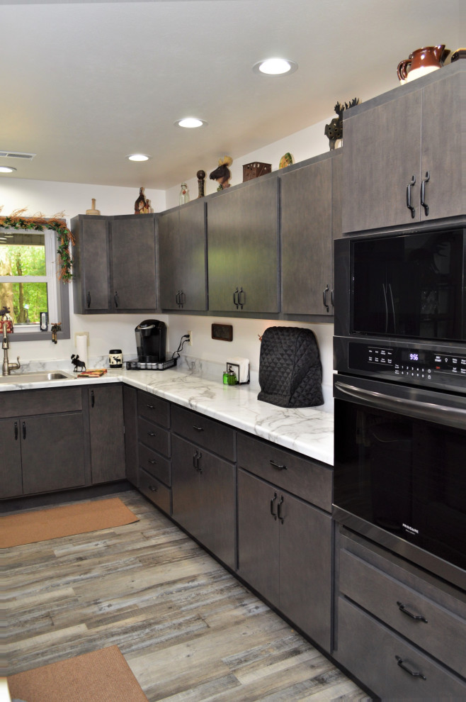 Foto på ett mellanstort funkis gul kök, med en nedsänkt diskho, släta luckor, grå skåp, laminatbänkskiva, laminatgolv, en köksö och grått golv