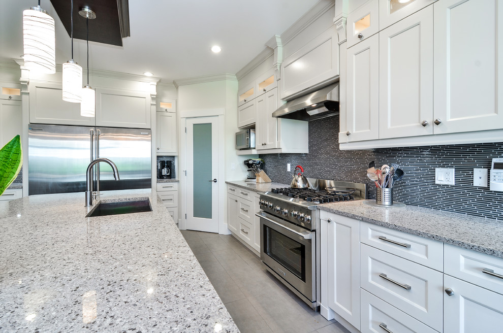 Example of a large minimalist l-shaped linoleum floor eat-in kitchen design in Vancouver with shaker cabinets, an island, white cabinets, an undermount sink, quartzite countertops, black backsplash, matchstick tile backsplash and stainless steel appliances