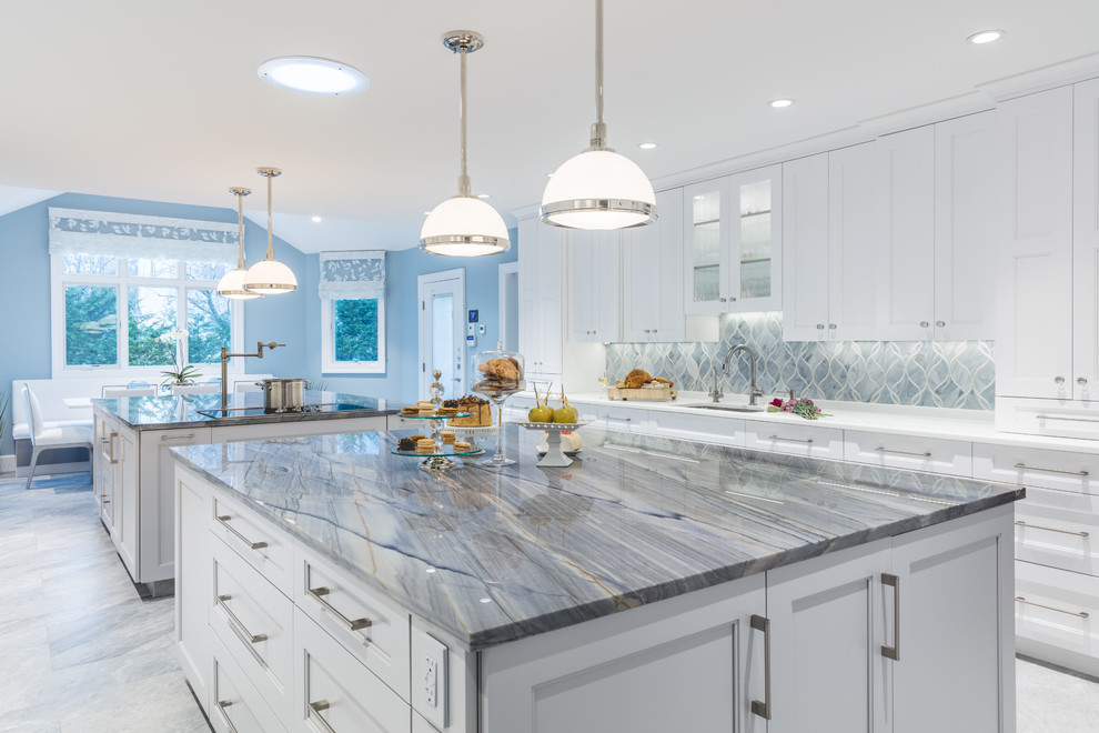 Inspiration for a huge contemporary u-shaped ceramic tile eat-in kitchen remodel in New York with a single-bowl sink, shaker cabinets, white cabinets, quartzite countertops, gray backsplash, glass sheet backsplash, stainless steel appliances and two islands