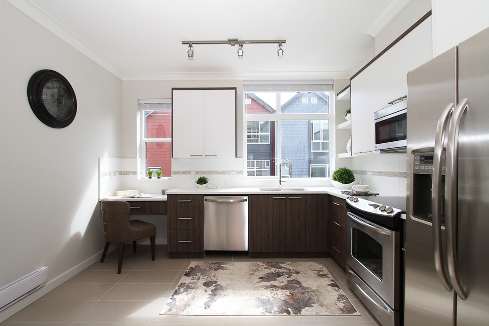 This is an example of a medium sized contemporary l-shaped kitchen in Vancouver with flat-panel cabinets, white cabinets, engineered stone countertops, white splashback, stainless steel appliances and ceramic flooring.