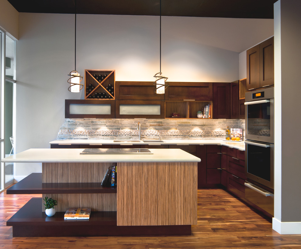 Moderne Küche mit Schrankfronten im Shaker-Stil, dunklen Holzschränken, Küchenrückwand in Grau, Rückwand aus Steinfliesen und braunem Holzboden in Minneapolis