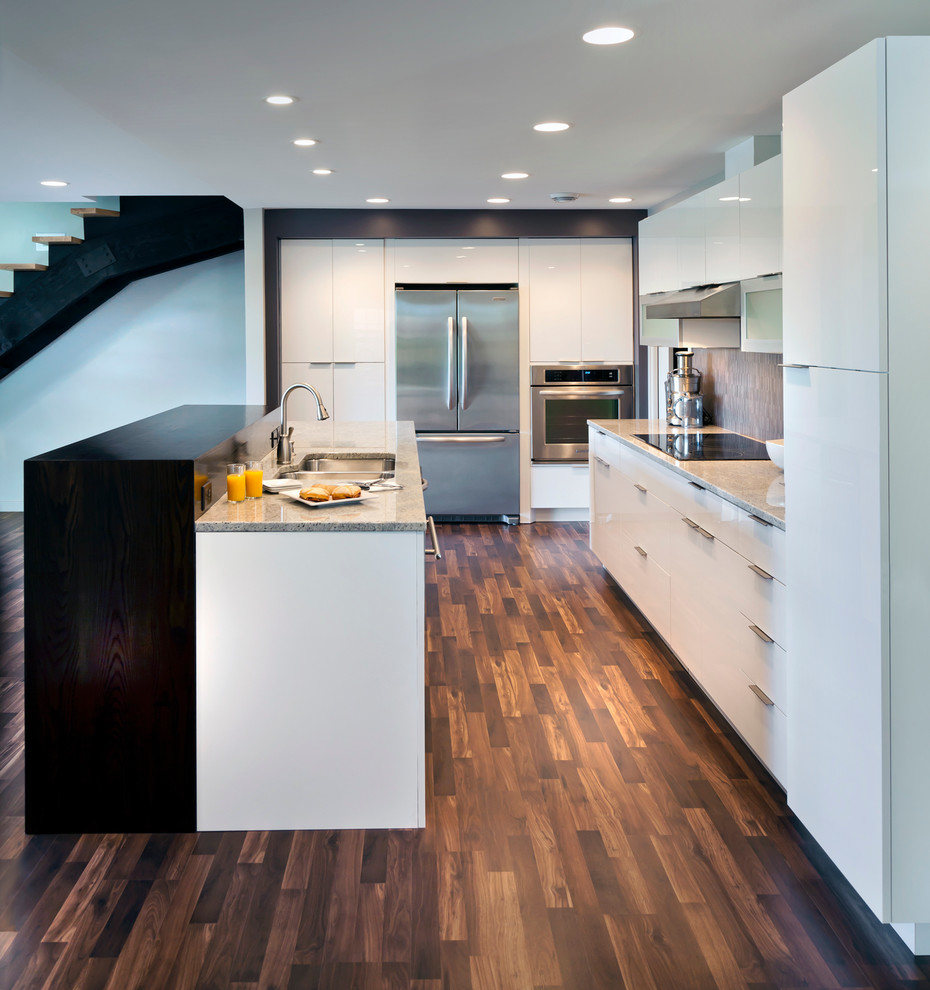 Inspiration for a contemporary l-shaped kitchen in Minneapolis with flat-panel cabinets, white cabinets, grey splashback, stainless steel appliances, dark hardwood flooring and a double-bowl sink.