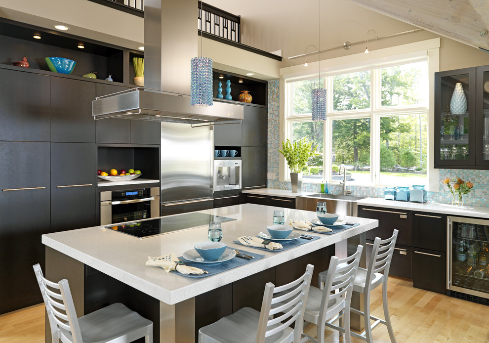 Trendy kitchen photo in Boston with mosaic tile backsplash, stainless steel appliances, quartz countertops, blue backsplash, flat-panel cabinets, dark wood cabinets and a farmhouse sink