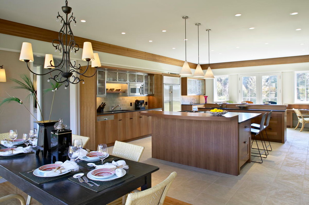 Example of a large zen u-shaped limestone floor and beige floor eat-in kitchen design in New York with a drop-in sink, flat-panel cabinets, medium tone wood cabinets, granite countertops, gray backsplash, stone slab backsplash, stainless steel appliances and two islands