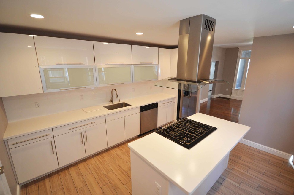 Trendy kitchen photo in Miami with flat-panel cabinets, white cabinets, stainless steel appliances and an island