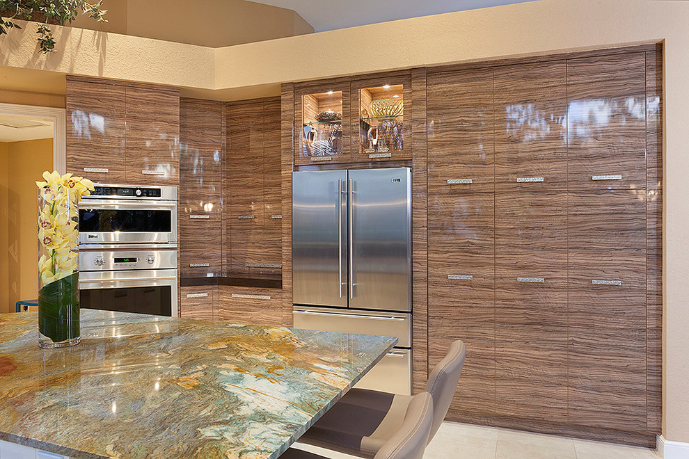 Example of a large trendy single-wall ceramic tile and beige floor eat-in kitchen design in Miami with an island, medium tone wood cabinets, stainless steel appliances, flat-panel cabinets, marble countertops and multicolored countertops