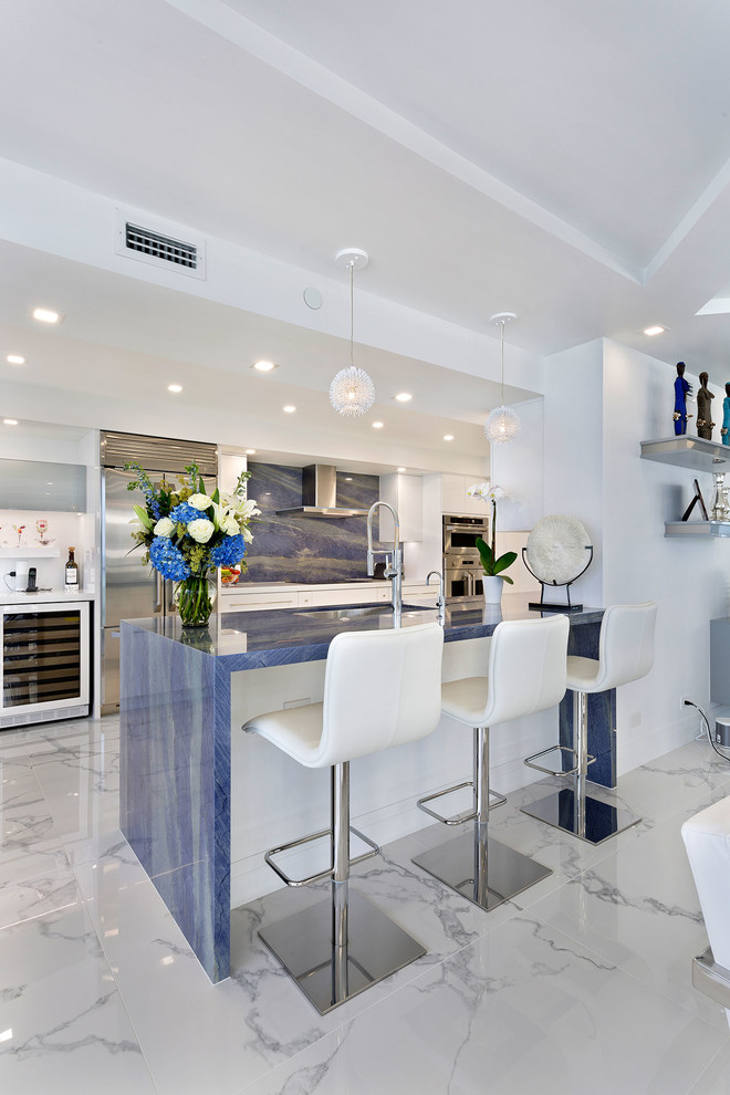 Medium sized contemporary galley kitchen/diner in Miami with a submerged sink, flat-panel cabinets, white cabinets, marble worktops, blue splashback, marble splashback, stainless steel appliances, marble flooring, no island, multi-coloured floors and blue worktops.