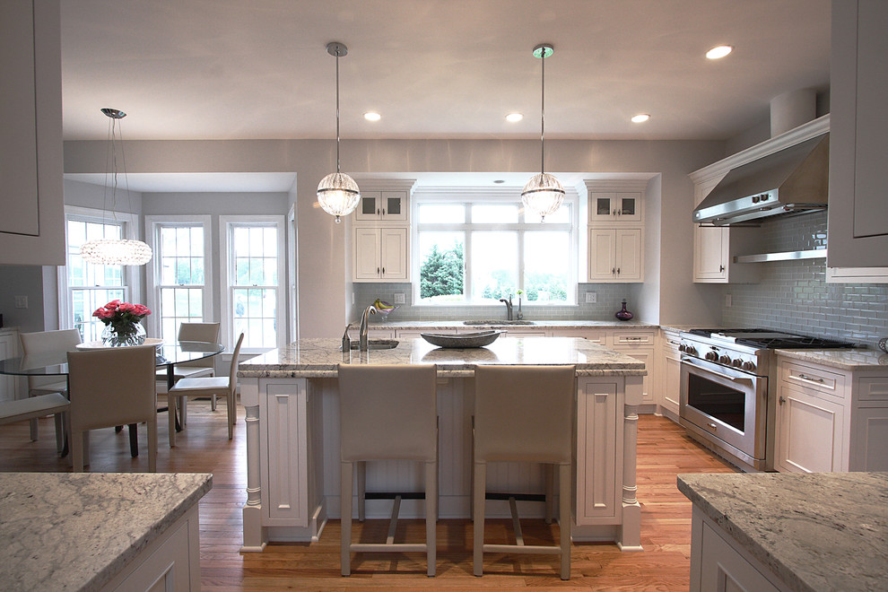 Inspiration for a traditional l-shaped kitchen/diner in DC Metro with recessed-panel cabinets, white cabinets, grey splashback and stainless steel appliances.