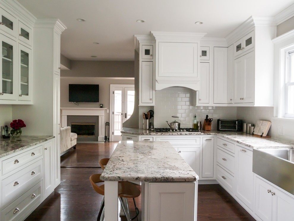 Enclosed kitchen - traditional enclosed kitchen idea in Chicago with stainless steel appliances, subway tile backsplash, a farmhouse sink, recessed-panel cabinets, white cabinets, granite countertops and white backsplash