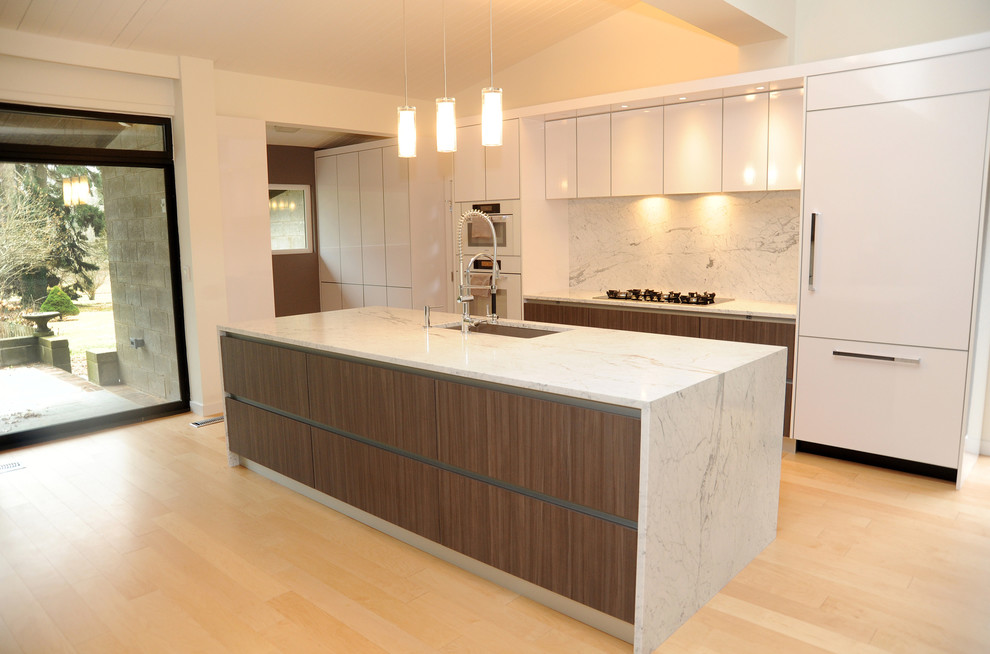 Example of a large trendy single-wall light wood floor eat-in kitchen design in Philadelphia with a drop-in sink, flat-panel cabinets, dark wood cabinets, marble countertops, white backsplash, white appliances, an island and stone slab backsplash