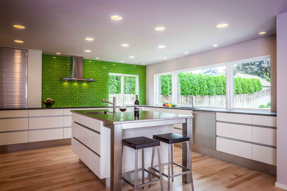 Inspiration for a large contemporary u-shaped light wood floor and beige floor eat-in kitchen remodel in Seattle with an undermount sink, flat-panel cabinets, white cabinets, quartz countertops, green backsplash, glass tile backsplash, stainless steel appliances and an island
