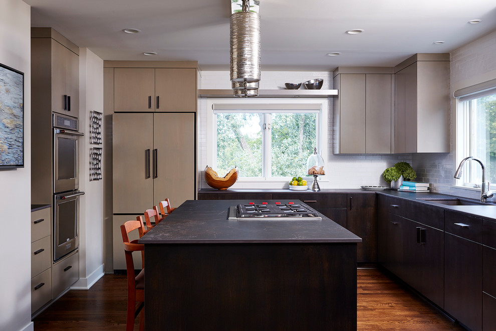 Inspiration for a contemporary u-shaped dark wood floor kitchen remodel in Minneapolis with white backsplash, subway tile backsplash and an island