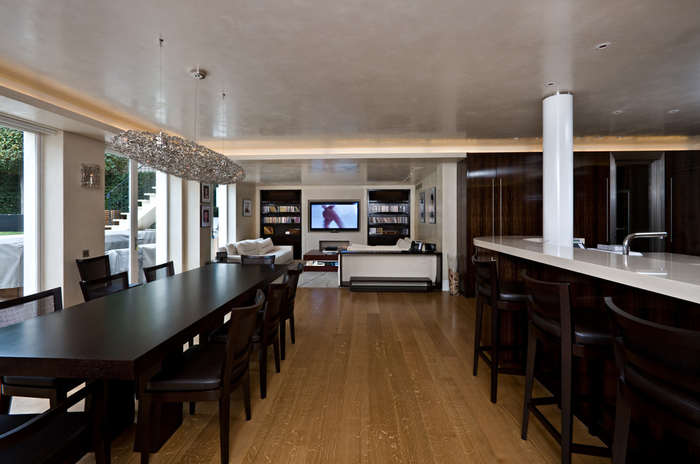 Design ideas for a contemporary open plan kitchen in London with flat-panel cabinets and dark wood cabinets.